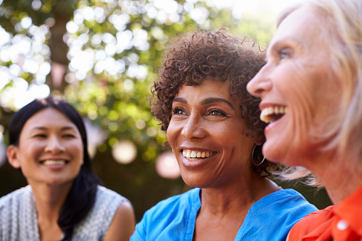 A group of smiling older women with dental implants from East Portland Dentistry in Portland, OR