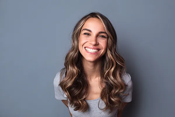 Joyful white woman showing off her beautiful teeth with a smile.